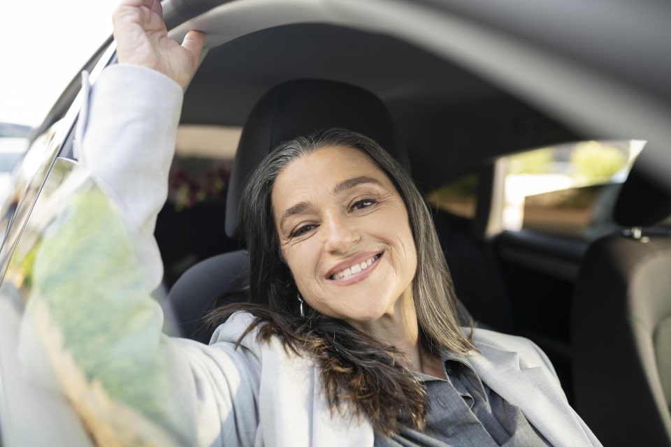 A senior businesswoman in a taxi