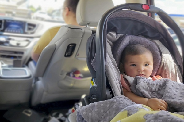 girl is seen sitting rear facing in her car 